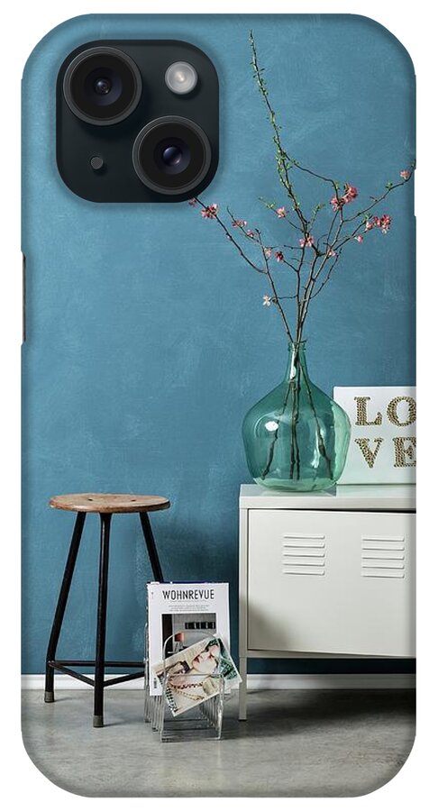 Ip_11270086 iPhone Case featuring the photograph Vintage Arrangement Of Old Stool, Metal Locker, Flowering Branches In Demijohn And Diy String Art Picture Against Blue-grey Wall by Michael Tasca