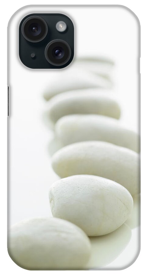 White Background iPhone Case featuring the photograph White Stones Lined Up On A White by Rick Lew