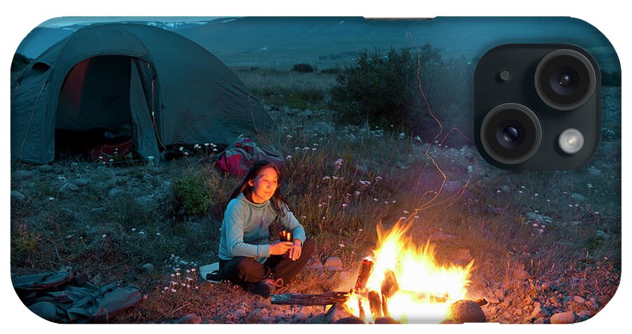 Campfire iPhone Case featuring the photograph Woman Sitting By Campfire In Iceland by Cavan Images
