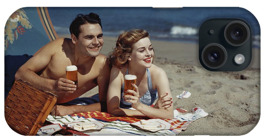 People iPhone Case featuring the photograph Young Couple Lying On Beach With Beer by Tom Kelley Archive