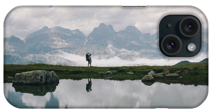 0-1 Years iPhone Case featuring the photograph Young Woman Stands At The View With Her Son In The Baby Carrier, Spain by Cavan Images