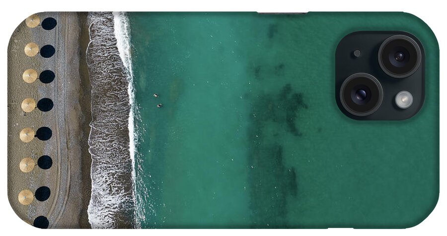 Summertime iPhone Case featuring the photograph Aerial view from a flying drone of beach umbrellas in a row on an empty beach #2 by Michalakis Ppalis