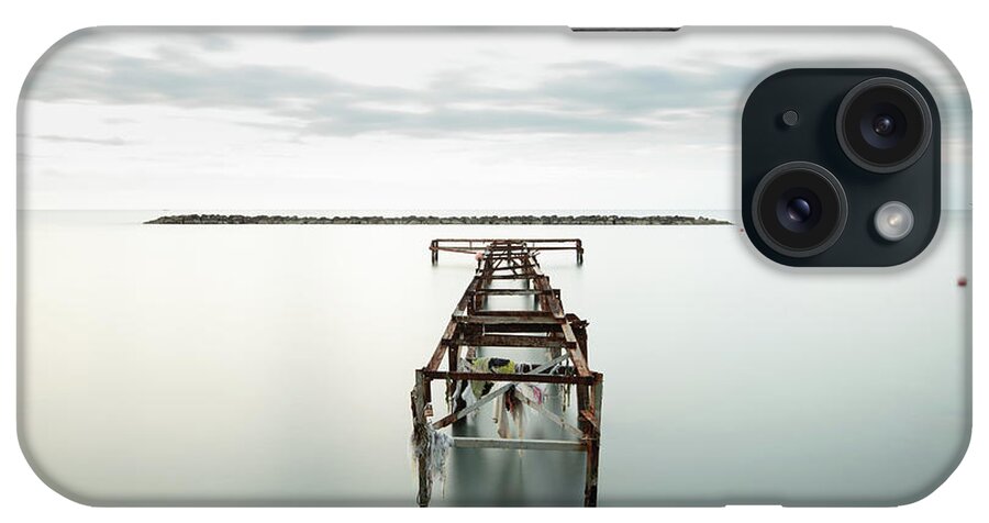Jetty iPhone Case featuring the photograph Abandoned pier in the ocean. Long Exposure by Michalakis Ppalis