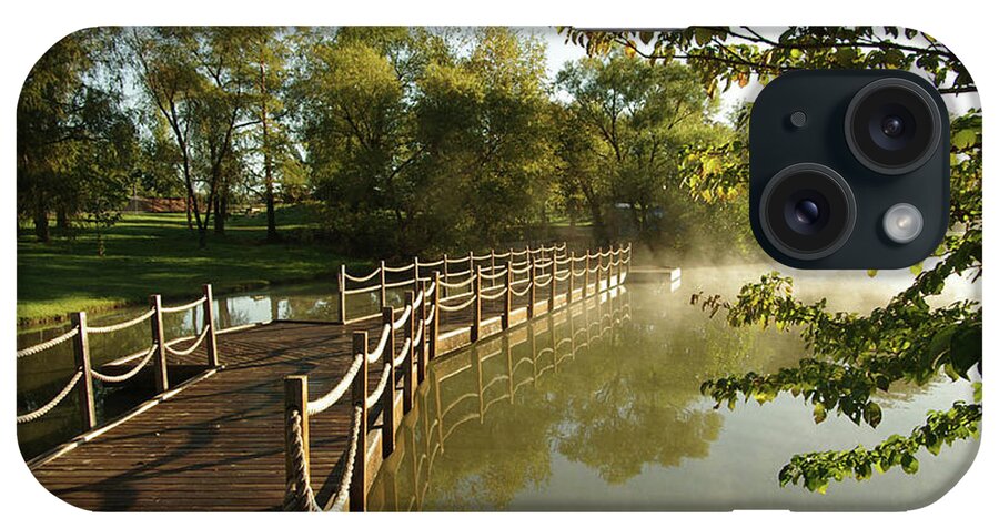 Foot Bridge iPhone Case featuring the photograph Bridge over a pond at sunrise by Jim Mathis