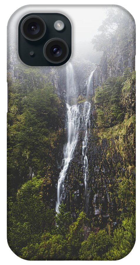 Risco Waterfall iPhone Case featuring the photograph Majestic Risco waterfall immersed in mist and rain on the island of Madeira, Portugal. Discovering magical places in Europe by Vaclav Sonnek