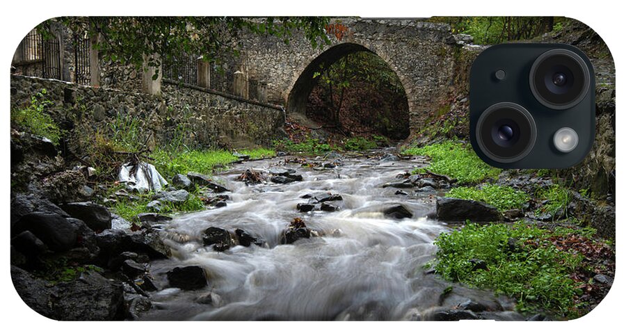 River iPhone Case featuring the photograph Medieval stoned bridge water flowing in the river. by Michalakis Ppalis