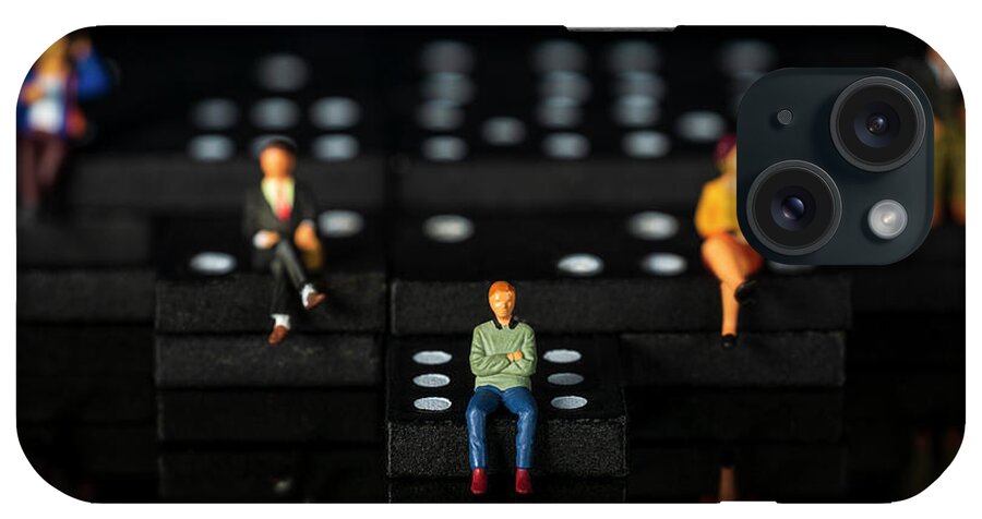 Conceptual iPhone Case featuring the photograph miniature people on dominoes Black background Macro by Pablo Avanzini