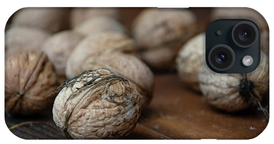 Nuts iPhone Case featuring the photograph Nuts on a wooden table by Martin Vorel Minimalist Photography