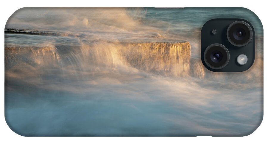 Stormy Sea iPhone Case featuring the photograph Stormy windy sea waves splashing on a rocky seashore at sunset by Michalakis Ppalis