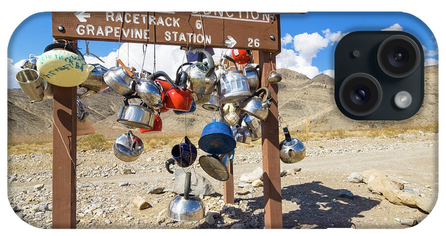 Road iPhone Case featuring the photograph Teakettle Junction and road sign covered by kettles and pans, Death Valley National Park, California by Neale And Judith Clark