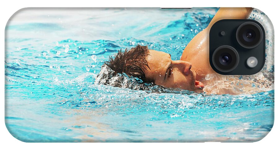 Swimmer iPhone Case featuring the photograph Young man swimmer train in swimming pool. by Jelena Jovanovic