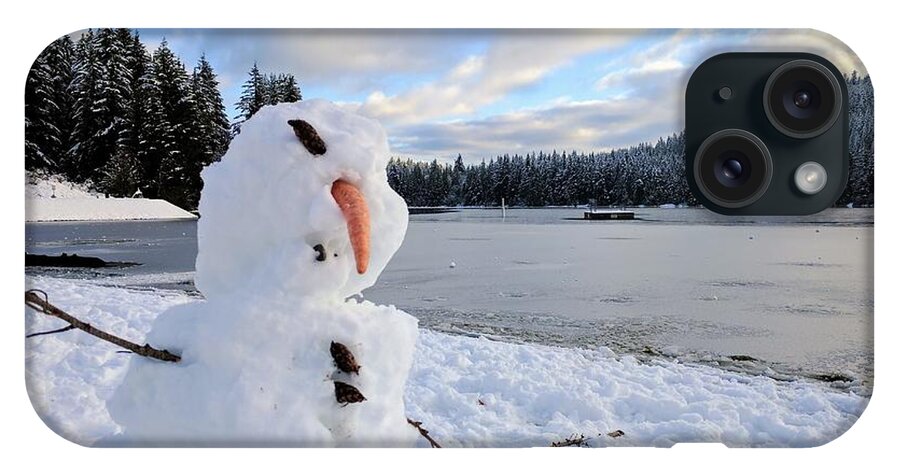 Closeup shot of a deformed snowman with a frozen lake in the background  during winter iPhone 15 Plus Case by Marvin Solorzano - Pixels
