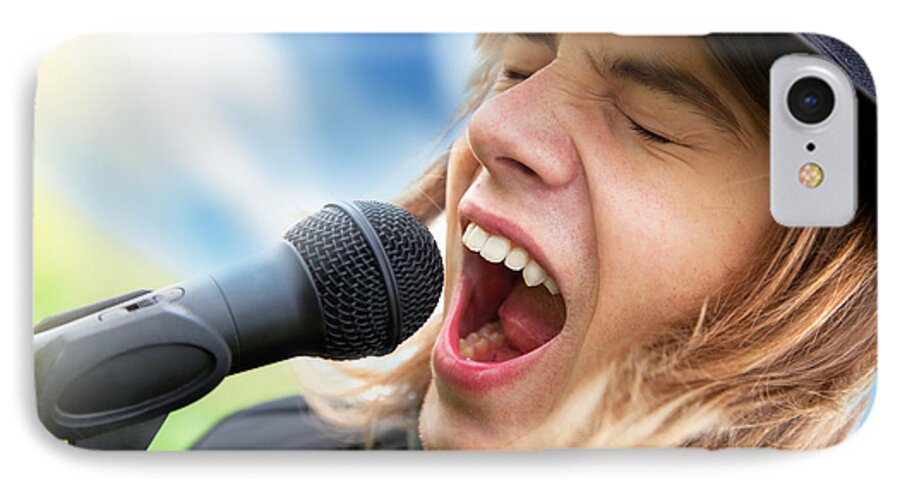 Sing iPhone 7 Case featuring the photograph A young man sings to a microphone by Michal Bednarek