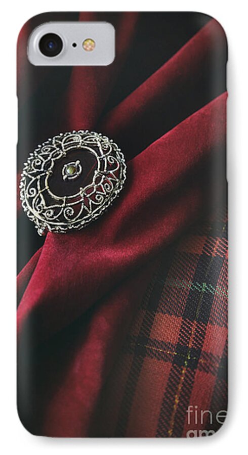 Atmosphere; Atmospheric; Ancient; Blade; Cavalier; Chevalier; Cloth; Dagger; Dark Age; Decorated; Decorative; Engraved; Engraving; Fabric; Fear; Iron; Jewellery; Jewelry; Knight-at-arms; Knights; Knives; Material; Medieval; Metal; Middle Ages; Old; Ornate; Red; Silver; Velvet; Highlander iPhone 7 Case featuring the photograph Brooch with red velvet and green plaid by Sandra Cunningham