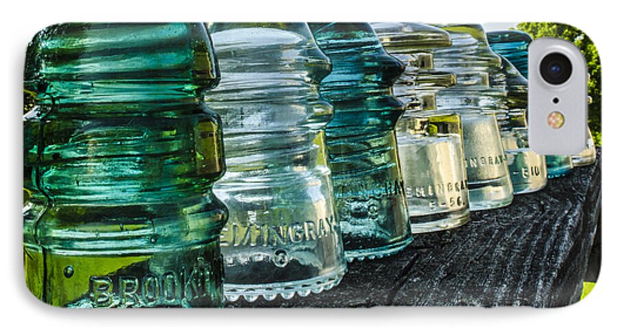 Glass Insulator iPhone 7 Case featuring the photograph Pretty Glass Insulators All in a Row by Deborah Smolinske