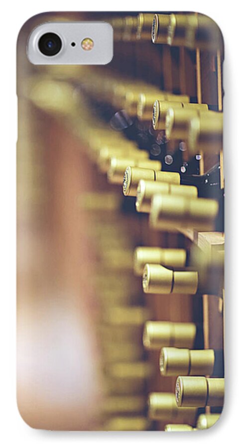 Room; Cellar; Many; Collection; Pantry; Beverage; Drink; Drinking; Alcohol; Alcoholic; Cork; Corks; Liquid; Macro; Blur; Blurred; Bottles; Food And Wine; Still Life; Object; Objects; Pattern; Compartments; Lighting iPhone 7 Case featuring the photograph Let's Crack One Open by Trish Mistric