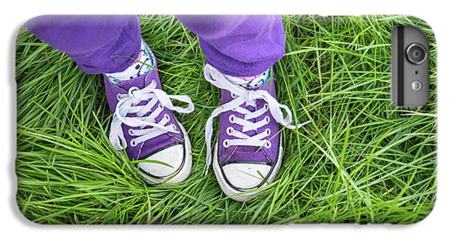 Girl Wearing Purple Pants And Shoes Standing In Long Green Grass
