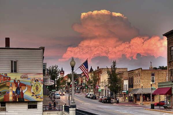 Stoughton Wi Wisconsin Norwegian Dancers Cumulonimbus Rain Storm Main Street Hwy 51 Yahara River Poster featuring the photograph Welcome to Stoughton - heritage mural and main street with cumulonimbus stormcloud in background by Peter Herman