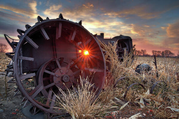 Tractor Abandoned Sunrise Vintage Case John Deere Antique Rust Corn Field Stubble Scenic Landscape Horizontal Metal Steampunk North Dakota Nd Rural Ag Agriculture Farming Poster featuring the photograph Sunrise through Abandoned Vintage Tractor Wheel by Peter Herman