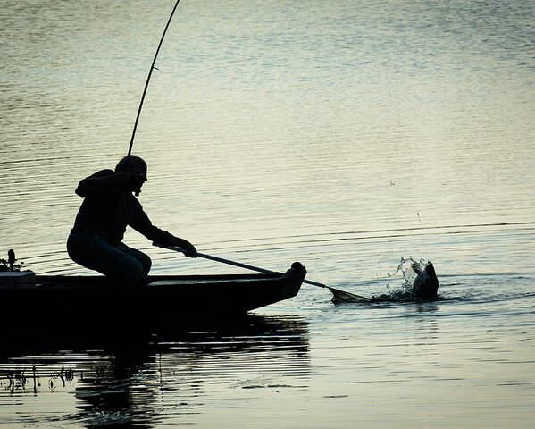 Fish Poster featuring the photograph Fisherman Catching Fish On A Twilight Lake by Andreas Berthold