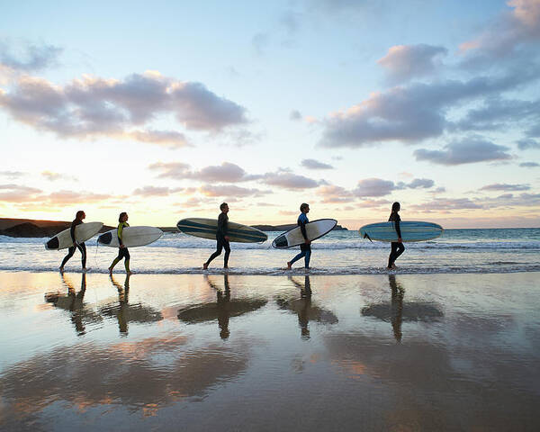 Summer Poster featuring the photograph Five Surfers Walk Along Beach With Surf by Dougal Waters