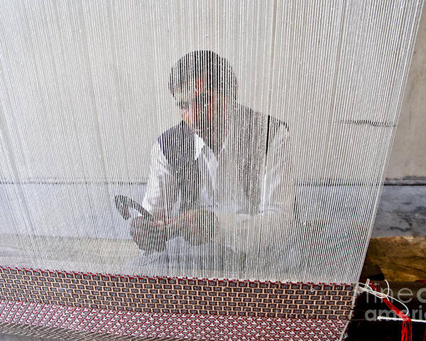 Carpet Weaving Poster featuring the photograph A weaver weaves a carpet. by Elena Perelman