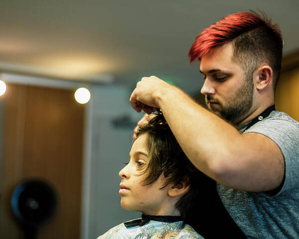 Man Cutting Hair Of Boy At Salon Poster by Cavan Images - Fine Art America