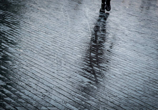 Silhouette Poster featuring the photograph Walking shadow of an unrecognised person walking on wet streets by Michalakis Ppalis