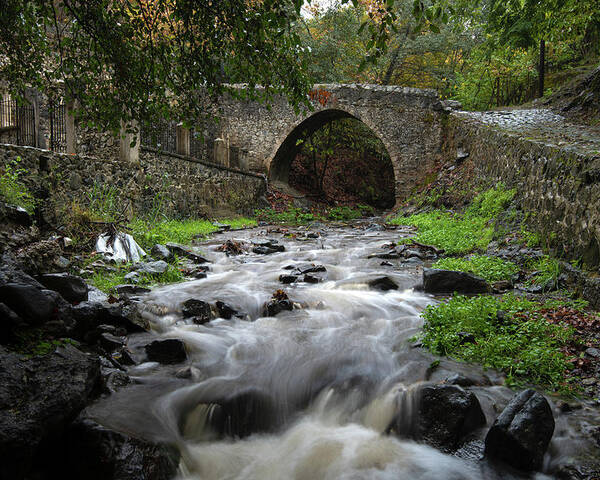 River Poster featuring the photograph Medieval stoned bridge water flowing in the river. by Michalakis Ppalis