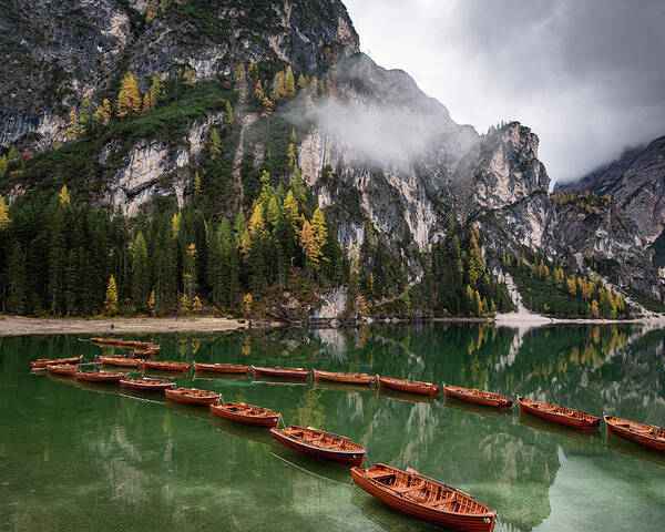 Lago Di Braies Poster featuring the photograph Wooden boats on the peaceful lake. Lago di braies, Italy by Michalakis Ppalis