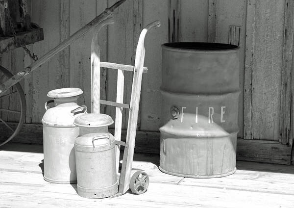 Black And White Poster featuring the photograph Milk Cans and Fire Barrel by Troy Montemayor