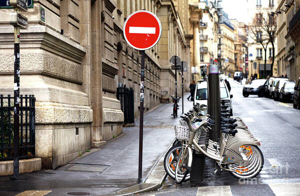 Bicyclettes Poster featuring the photograph Bicyclettes in the Paris Latin Quarter by John Rizzuto