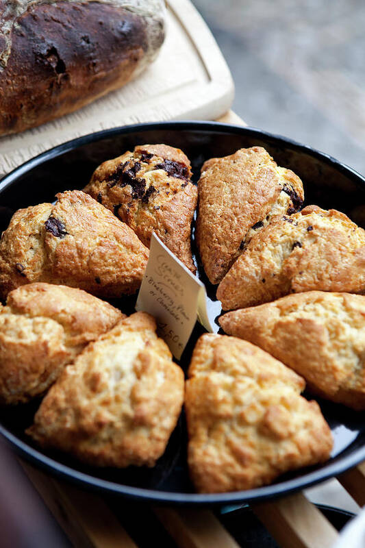 Breakfast Poster featuring the photograph A Variety Of Scones For Sale On Display by Halfdark