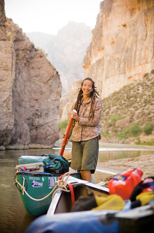 Adventure Poster featuring the photograph A Woman Unloads Gear From Her Canoe by David Nevala