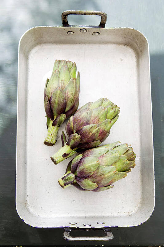 Roasting Pan Poster featuring the photograph Artichokes In Tray by Christine Schneider
