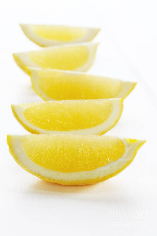 Lemon Poster featuring the photograph Lemon Wedges on White Background by Colin and Linda McKie
