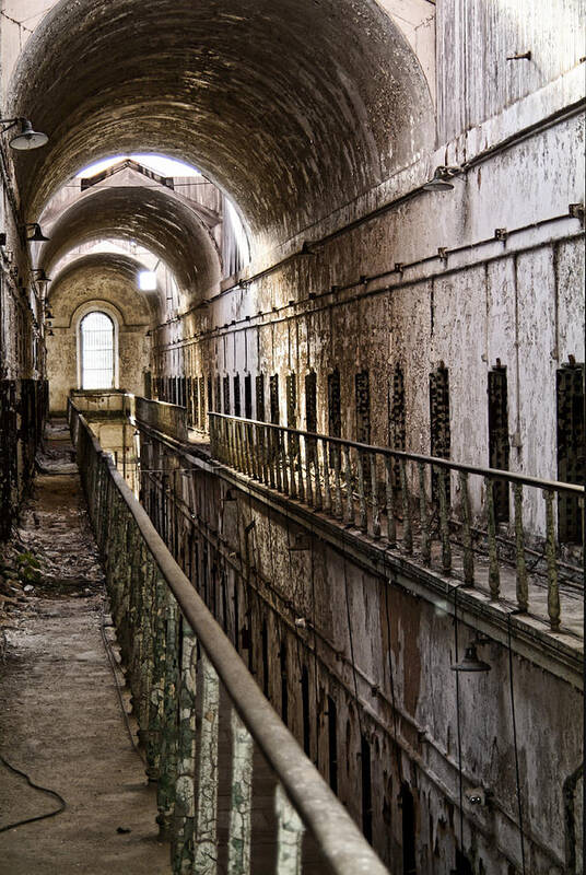 Eastern State Penitentiary Poster featuring the photograph Ominous Corridor by Michael Dorn
