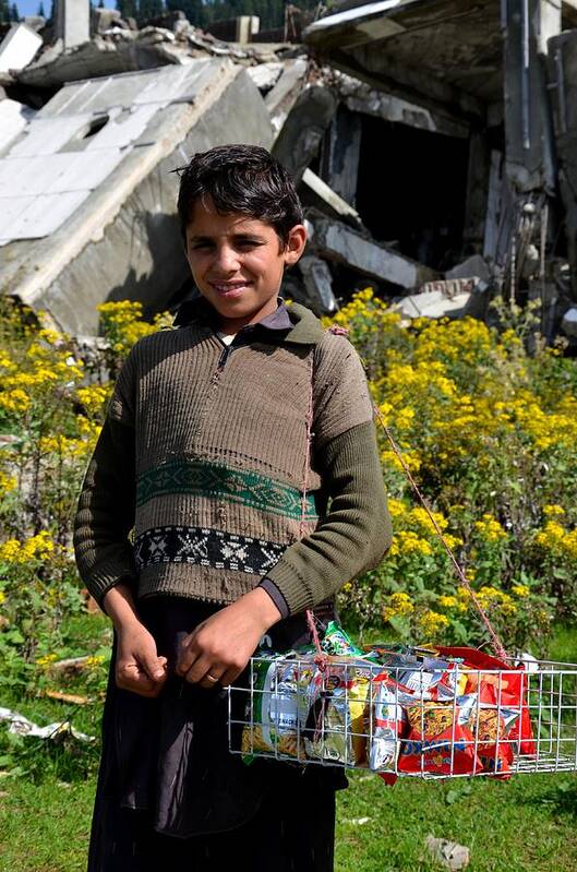 Boy Poster featuring the photograph Pakistani boy in front of hotel ruins in Swat Valley by Imran Ahmed