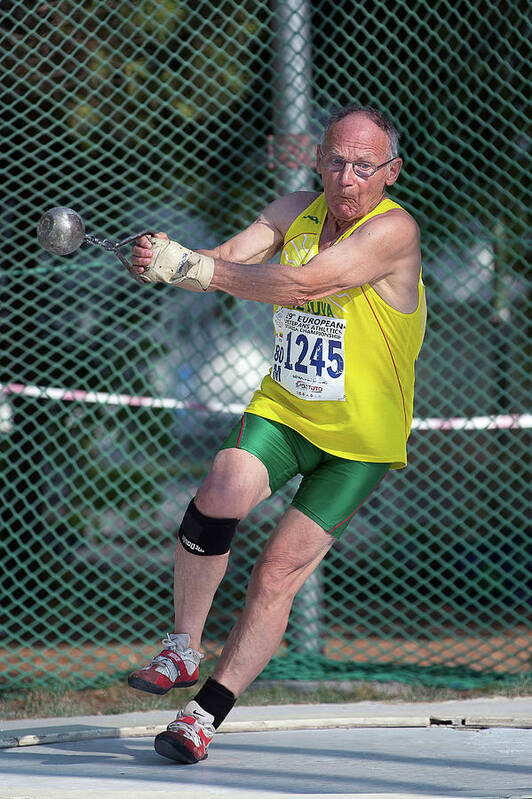 One Person Poster featuring the photograph Senior Athlete Prepares Hammer Throw by Alex Rotas