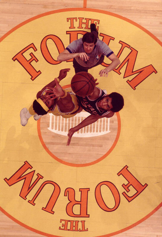 Marvin Newman Poster featuring the photograph Wilt Chamberlain Vs. Kareem Abdul Jabbar Tip Off by Retro Images Archive