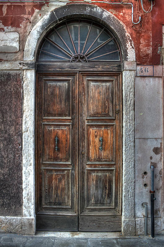 Door Poster featuring the photograph an old wooden door in Italy #1 by Joana Kruse