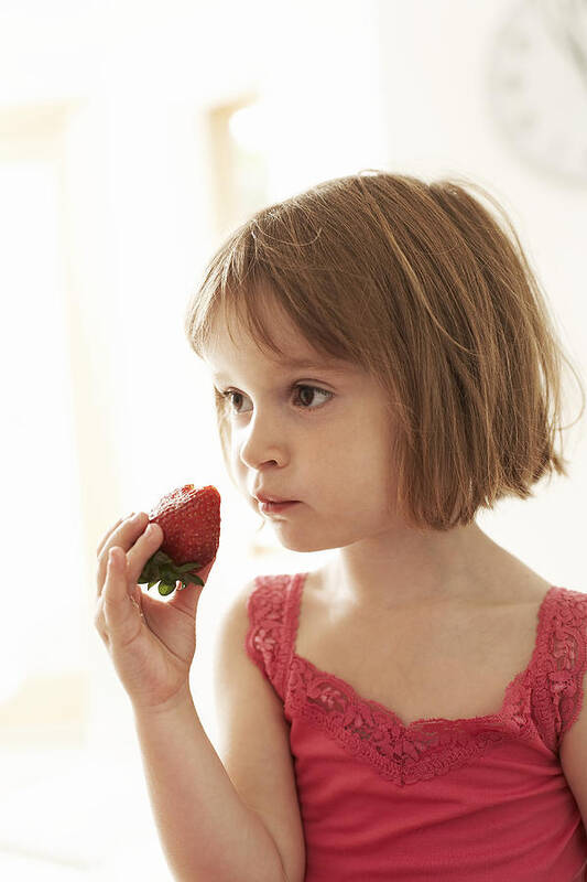 Fruit Poster featuring the photograph Girl Eating A Strawberry by Ian Boddy