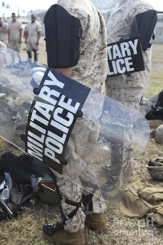 Law Enforcement Poster featuring the photograph U.s. Marines And Sailors Don Riot Gear by Stocktrek Images