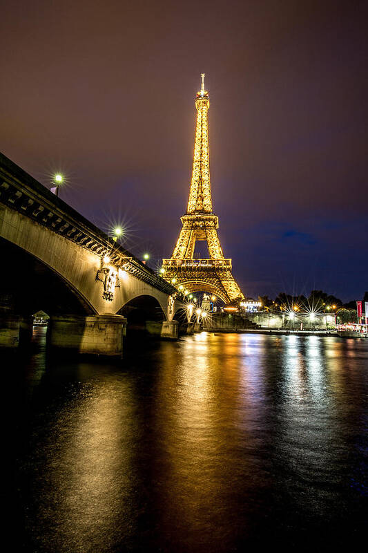 Paris Poster featuring the photograph Eiffel Tower at Night by Lev Kaytsner