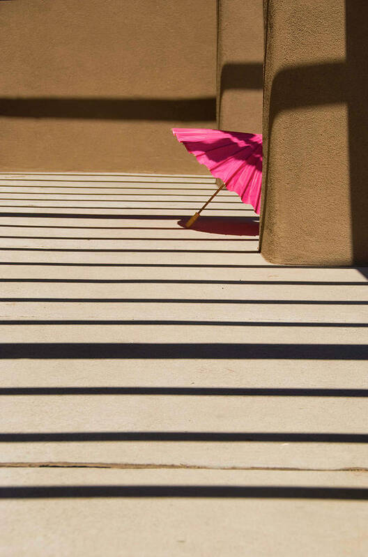 Umbrella Shadows Pink Adobe Santa Fe Poster featuring the photograph Pink umbrella by Carolyn D'Alessandro