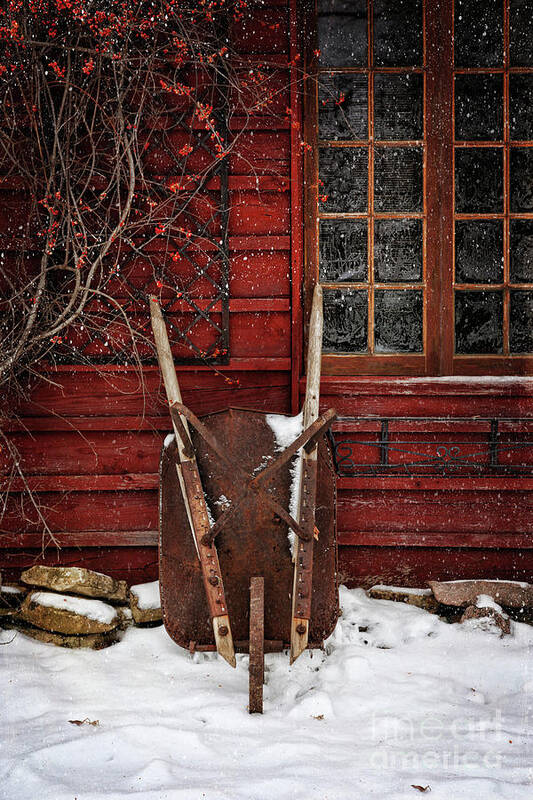 Atmosphere Poster featuring the photograph Rusty wheelbarrow leaning against barn in winter by Sandra Cunningham