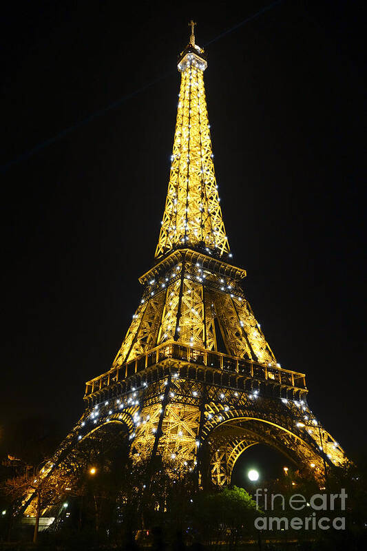 Eiffel Tower Poster featuring the photograph The Eiffel tower at night illuminated, Paris, France. by Perry Van Munster