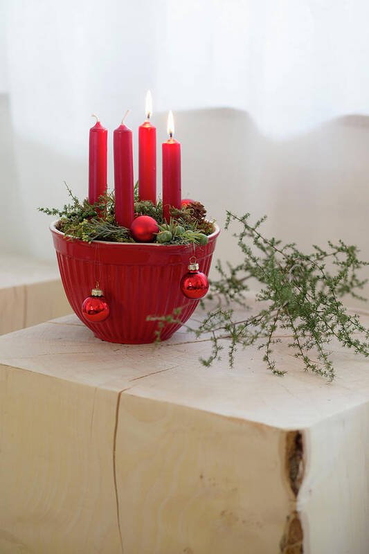 Ip_12478159 Poster featuring the photograph Advent Arrangement Of Four Red Candles In Red Mixing Bowl by Iris Wolf