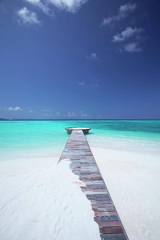 Water's Edge Poster featuring the photograph Jetty Leading To Ocean, Maldives by Sakis Papadopoulos