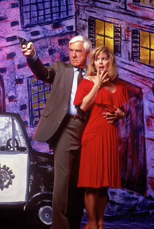 Leslie Nielsen Poster featuring the photograph LESLIE NIELSEN and PRISCILLA PRESLEY in THE NAKED GUN FROM THE FILES OF POLICE SQUAD -1988-. by Album